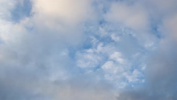 Puffy fluffy two layers of white clouds on windy Blue sky. cloudscape timelapse. Nature weathe