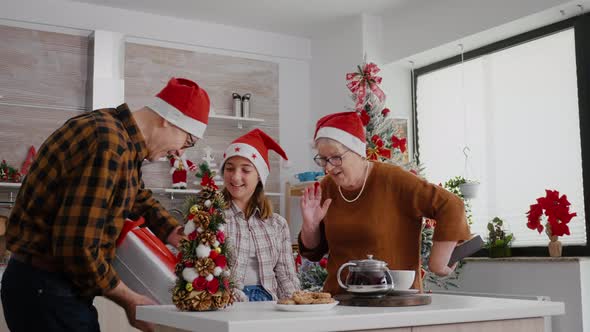 Happy Family Enjoying Winter Holiday Celebrating Christmas Season Standing at Table alt