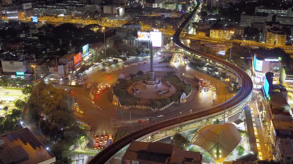 Aerial view of Victory Monument with car light trails on busy street road. Roundabout in Bangkok