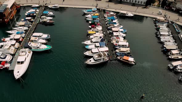 Aerial top down view of sea dock with colorful boats. Top view harbor. Travel alt