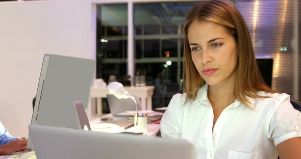 Businesswoman working over laptop alt