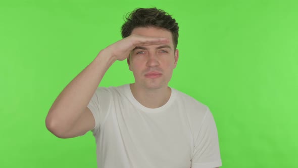 Young Man Searching Opportunity on Green Background alt