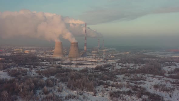 The Thermal Power Plant Works at Full Capacity in the Cold Winter During the Day Near the City