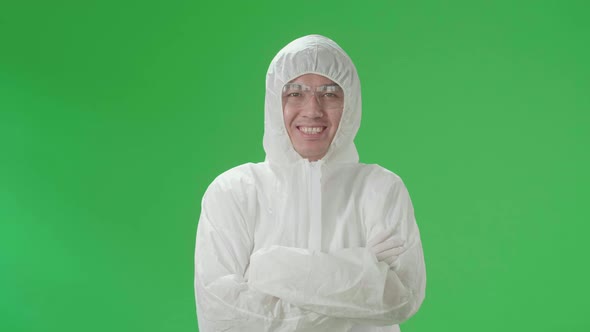 Male Wearing Personal Protective Equipment Uniform Ppe Pose With Arms Crossed In Green Screen Studio alt