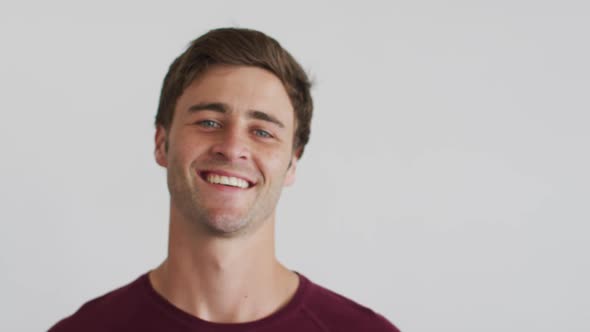 Portrait of caucasian man looking at camera and smiling alt