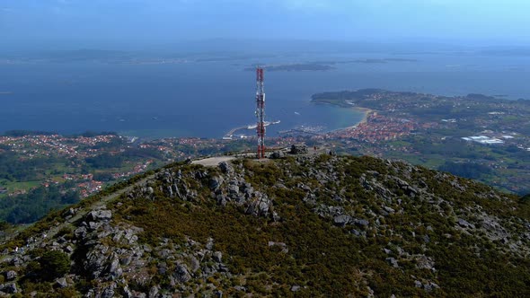 Aerial View Of Telecommunications Mast On Rocky Hillside In Miradoiro da Curota With Ria de Arousa I alt
