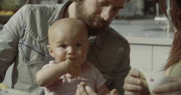 Daughter eating cake with parents