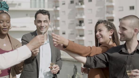 Front View of Employees Lighting Sparklings at Business Party alt