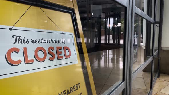 This restaurant is closed, sign in shop window in empty shopping centre