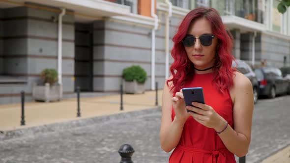 Red Hair Girl Uses Blue Smartphone