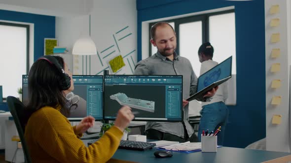 Engineers Talking in Front on Pc and Laptop with CAD Software alt