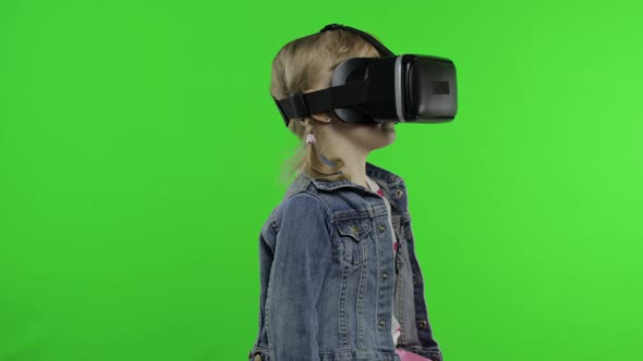 Child Girl Using VR Headset Helmet To Play Game. Watching Virtual Reality 3d 360 Video. Chroma Key alt