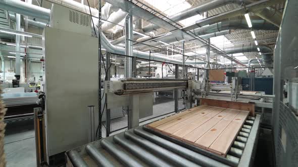 automatic conveyor makes many pieces of parquet board move fast in manufacturing plant alt