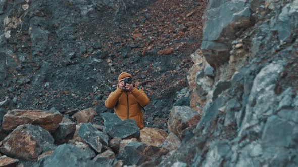 Traveler Photographer Takes Photos on Telephoto Lens in Mountains alt