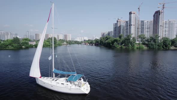 Aerial View of a White Sailing Yacht on the Background of Kyiv City