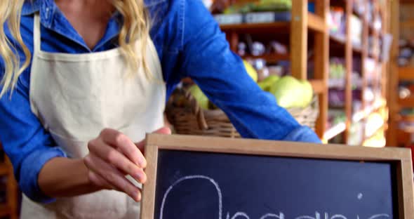 Female staff holding organic sign board alt