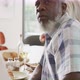 Portrait of happy senior diverse people having dinner at retirement home