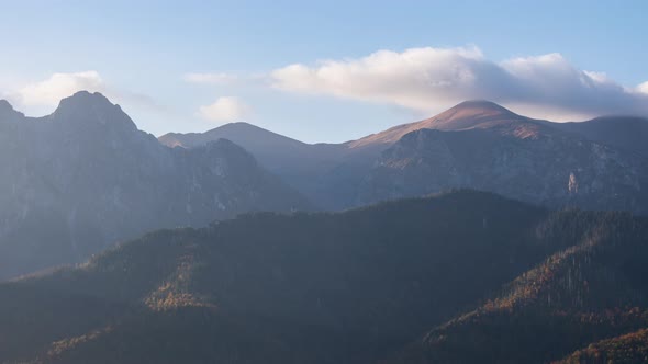 Time Lapse Shot Mountains Peaks Mountain Range Covered with Rolling Clouds Lit with Warm Morning Sun alt
