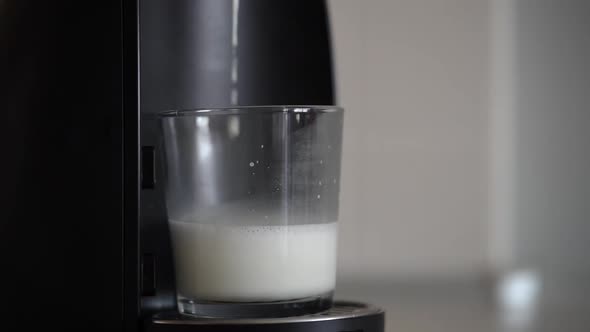 Home Capsule Coffee Machine Prepares a Cup of Fresh Cappuccino alt