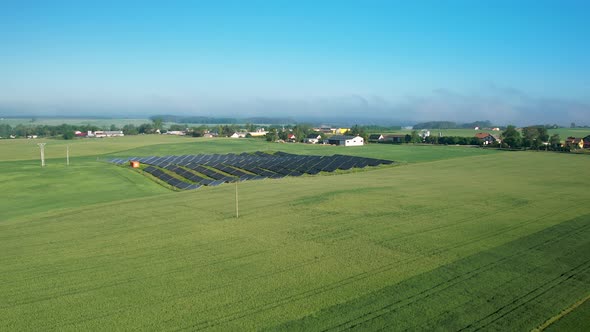 Orbiting drone shot of solar panel farm. Renewable green energy. alt