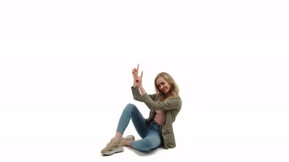 Copy Space of a Young Casually Dressed Blondhaired Girl Energetically Pointing with Her Fingers Up alt