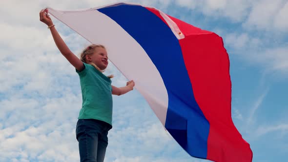 Blonde Girl Waving National Russia Flag Outdoors Over Blue Sky at Summer Russian Flag Country alt
