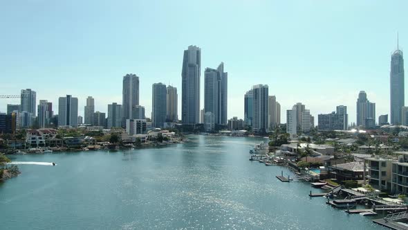 Rapidly ascending drone footage revealing Surfers Paradise in the early morning sun alt