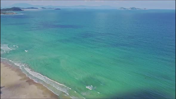 Aerial View Motion From Coast Over Azure Ocean To Horizon alt