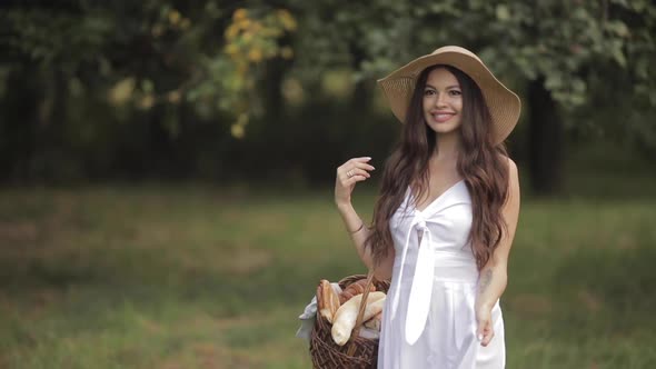 Beautiful Lady in a Straw Hat Sauntering in the Park