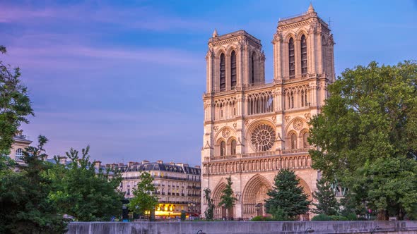 Front View of Notre Dame De Paris Cathedral Day To Night Timelapse After Sunset alt