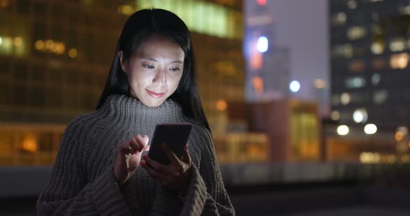 Young Woman Using Mobile Phone at Night alt