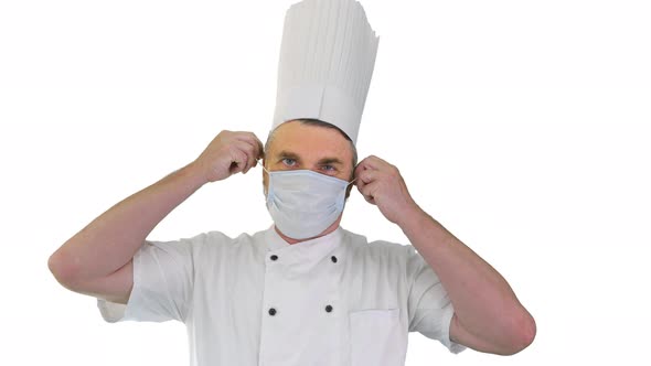 Male Chef Cook Taking Medical Mask Off and Smiling To Camera on White Background alt
