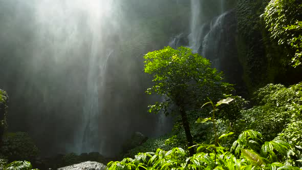 Large water fall hitting a pool