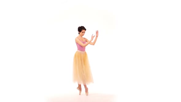 Ballerina Is Dancing in the Studio on a White Cyclorama
