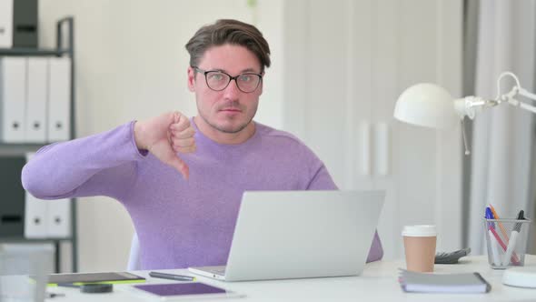 Thumbs Down By Middle Aged Man with Laptop  alt