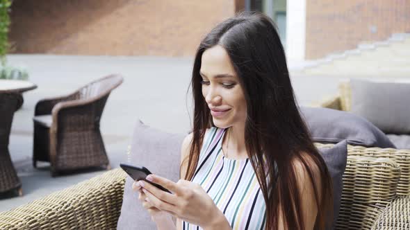 Portrait Brunette in Striped Dress Use Smartphone