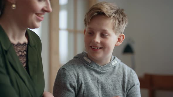 Focused Shot of Boy Reading and Studying with His Older Sister alt