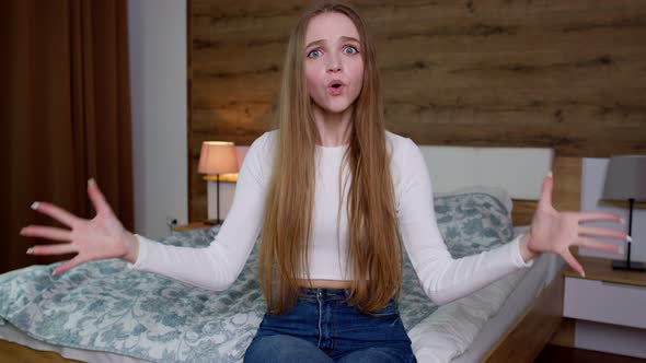 Irritated Woman in White Blouse Raising Hands in Questioning Gesture Why What Indignant Expression alt