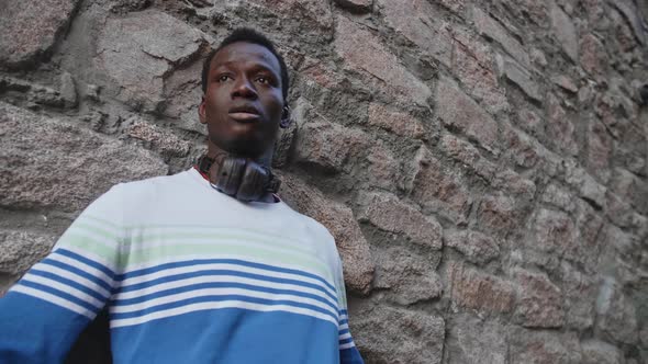 A Young Black Guy Poses Against the Backdrop of a Beautiful Theater Building