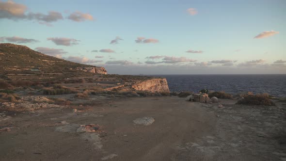 Sunset Paints Purple Colour Cast on Plateu near Coastline in Mediterranean Sea in Malta alt