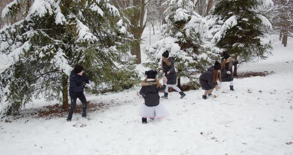 Happy Children Playing Snowballs In A Snowy Park. Fun Winter Games On The Street. Healthy Lifestyle
