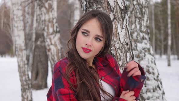 Woman with Red Lips in Winter Forest