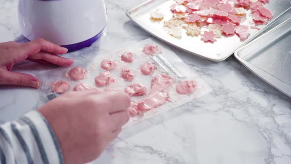 Step by step. Pouring melted chocolate into a plastic chocolate mold in the shape of snowflakes. alt