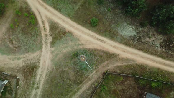 Crossroads Of Unpaved Rural Roads. In The Center Of The Intersection Is A Nest With Storks