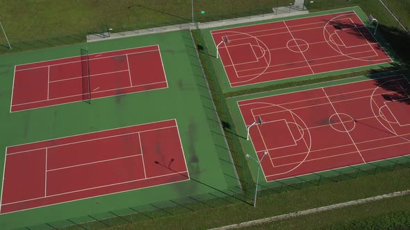 View From the Height of the Empty Tennis Courts in the Daytime in Summer alt