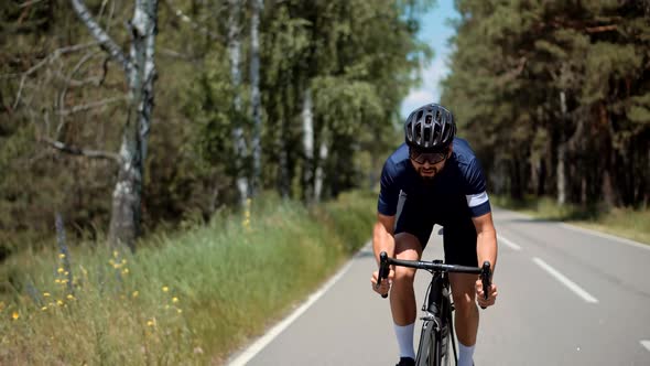 Cyclist Training On Bicycle. Fit Athlete Workout Training Cycling For Triathlon Competition. alt