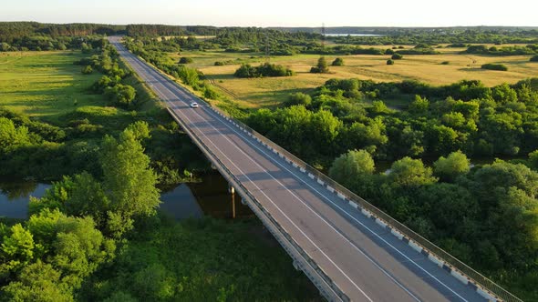 A Bridge That Cars Drive Across A Wide River