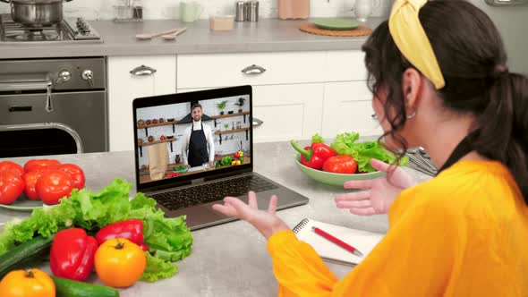 Emotional Positive Housewife in Home Kitchen Study Online Video Call Tells Chef alt