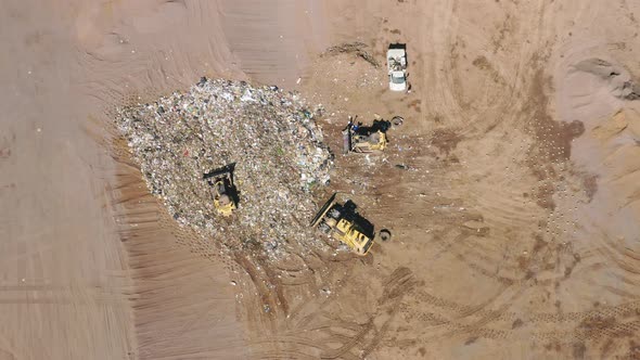 Bulldozers Driving By Landfill Leveling Garbage and Human Waste Plastic Bags alt