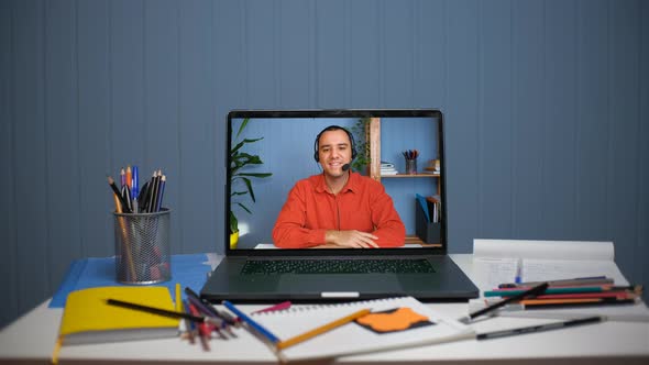 Young Man in Headset with Microphone Holding Online Meeting Conversation alt